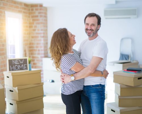 shutterstock_1507673714 couple with new home sign re size